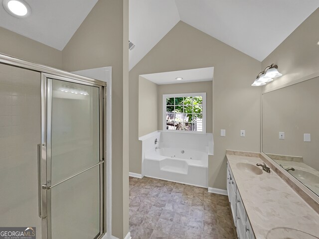 bathroom featuring tile flooring, lofted ceiling, plus walk in shower, and double sink vanity