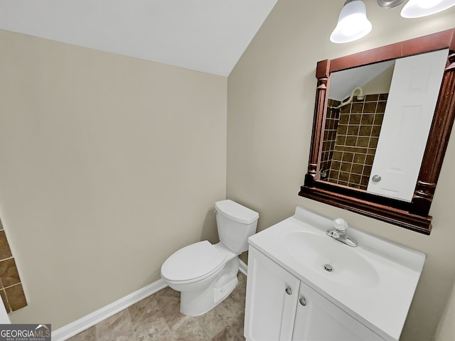 bathroom with vanity with extensive cabinet space, tile flooring, and toilet