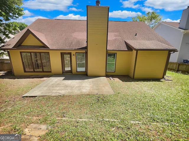 back of house with a yard and a patio area