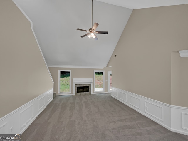 unfurnished living room featuring high vaulted ceiling, ornamental molding, a fireplace, and ceiling fan