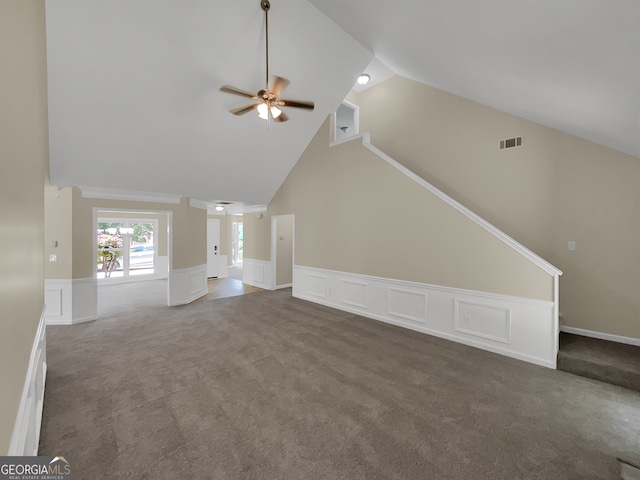 unfurnished living room with high vaulted ceiling, ceiling fan, and dark colored carpet