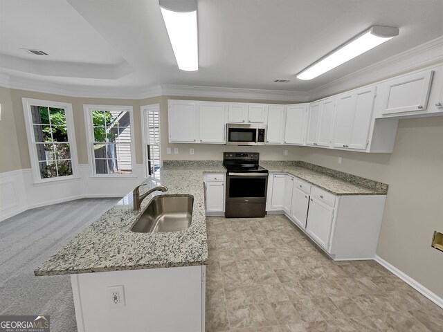 kitchen featuring white cabinetry, light carpet, electric range, light stone counters, and sink