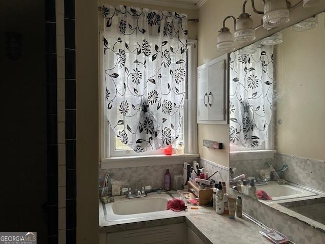 bathroom with crown molding and vanity