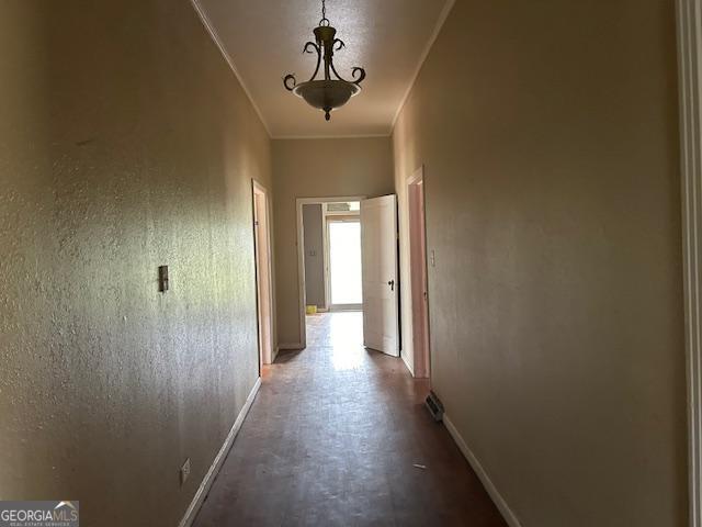 hallway featuring ornamental molding