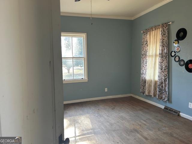 unfurnished room with hardwood / wood-style flooring and ornamental molding