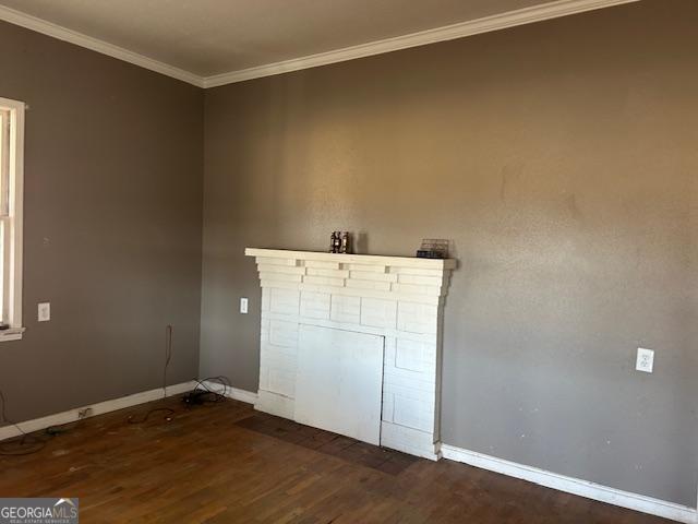 interior space with ornamental molding and dark hardwood / wood-style flooring