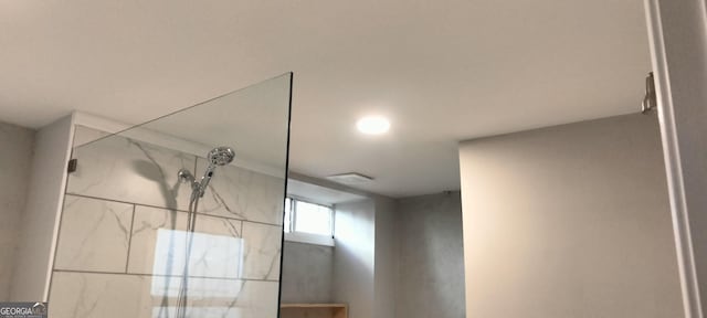 interior details with a tile shower