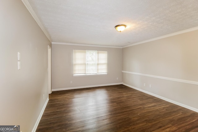 spare room featuring ornamental molding, baseboards, dark wood-style flooring, and a textured ceiling