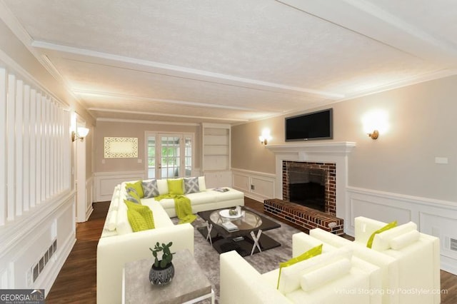 living area featuring dark wood finished floors, a decorative wall, and a brick fireplace