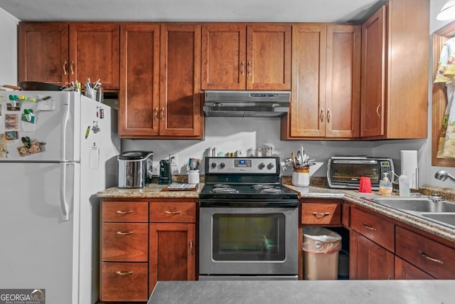 kitchen with sink, white fridge, and stainless steel electric range oven