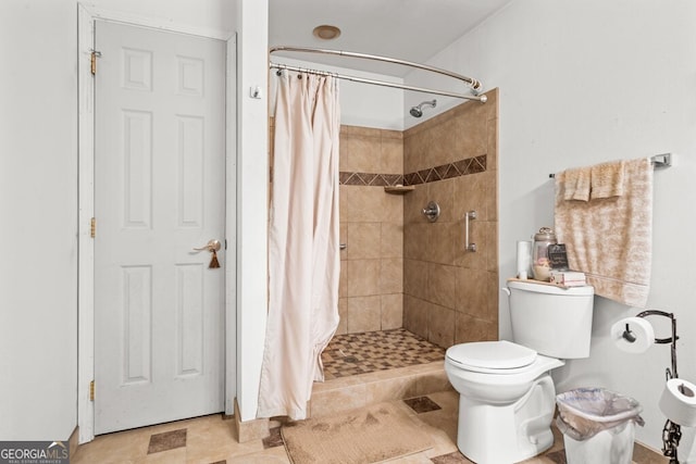 bathroom with a shower with curtain, tile floors, and toilet