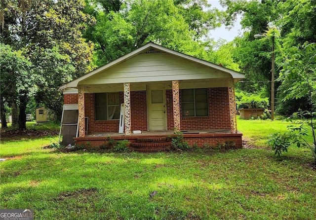 view of front of house with a front yard and a porch