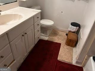 bathroom featuring vanity and toilet