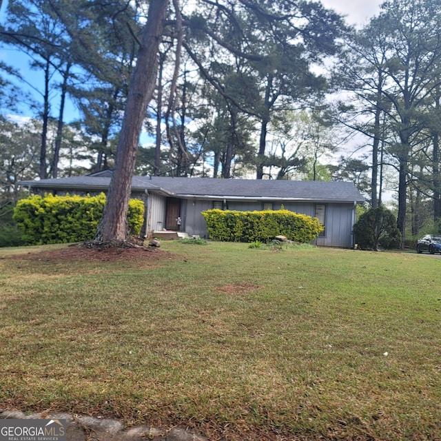 ranch-style house with a front lawn