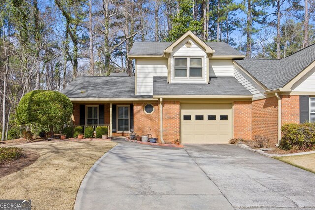 view of front of home with a front yard and a garage