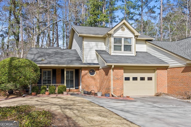 view of front facade featuring brick siding, a shingled roof, a garage, covered porch, and driveway