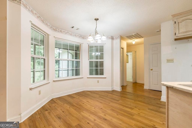 3650 Confederate Dr, Macon, GA 31211 - unfurnished dining area with a chandelier and light hardwood / wood-style flooring