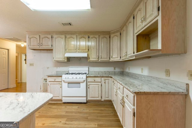 3650 Confederate Dr, Macon, GA 31211 - kitchen with white range with gas cooktop and light hardwood / wood-style flooring