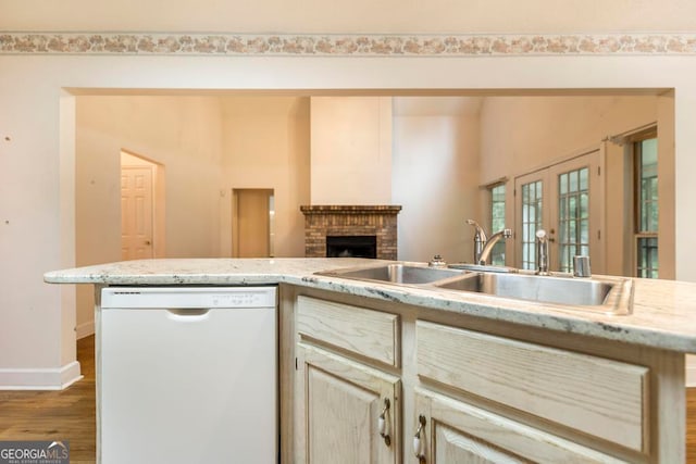 3650 Confederate Dr, Macon, GA 31211 - kitchen with white dishwasher, french doors, a fireplace, hardwood / wood-style floors, and sink