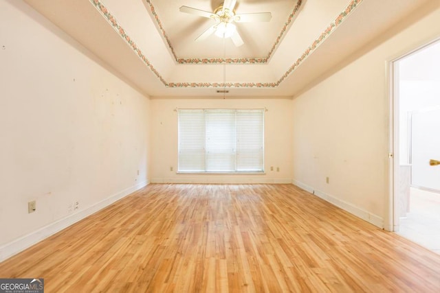 3650 Confederate Dr, Macon, GA 31211 - spare room with ceiling fan, a tray ceiling, and light hardwood / wood-style floors