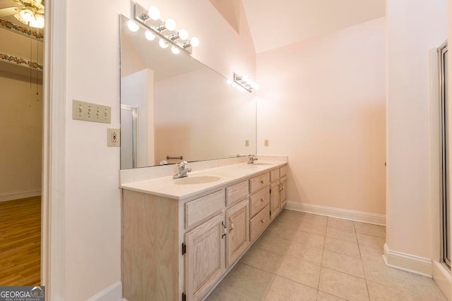 3650 Confederate Dr, Macon, GA 31211 - bathroom with tile floors, vaulted ceiling, and double sink vanity