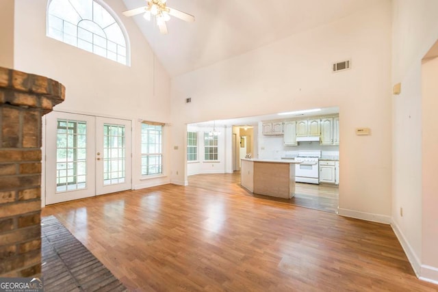 3650 Confederate Dr, Macon, GA 31211 - unfurnished living room with high vaulted ceiling, french doors, ceiling fan, and hardwood / wood-style floors