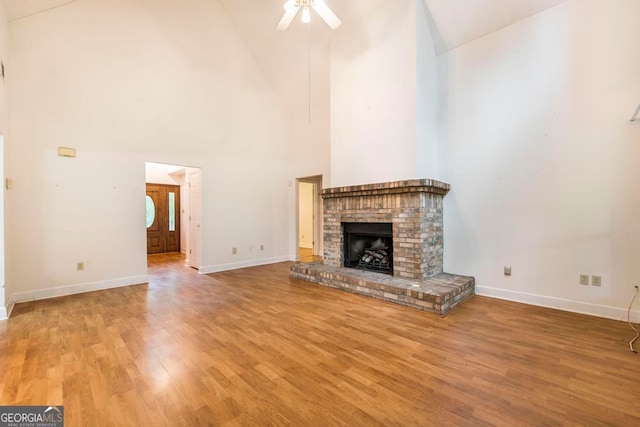 3650 Confederate Dr, Macon, GA 31211 - unfurnished living room featuring high vaulted ceiling, a brick fireplace, hardwood / wood-style floors, and ceiling fan