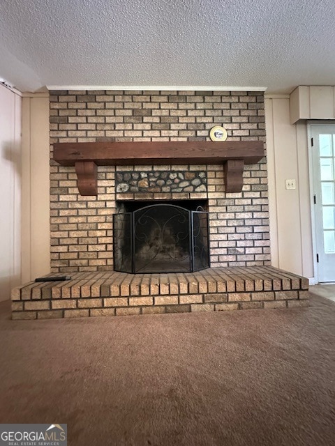 interior details with a brick fireplace, a textured ceiling, and carpet floors