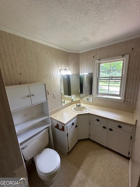 bathroom with tile flooring, vanity, toilet, and a textured ceiling