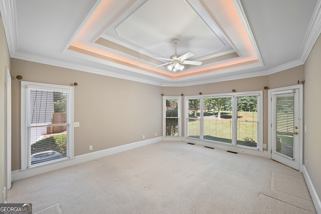 unfurnished room featuring ornamental molding, ceiling fan, a raised ceiling, and carpet floors