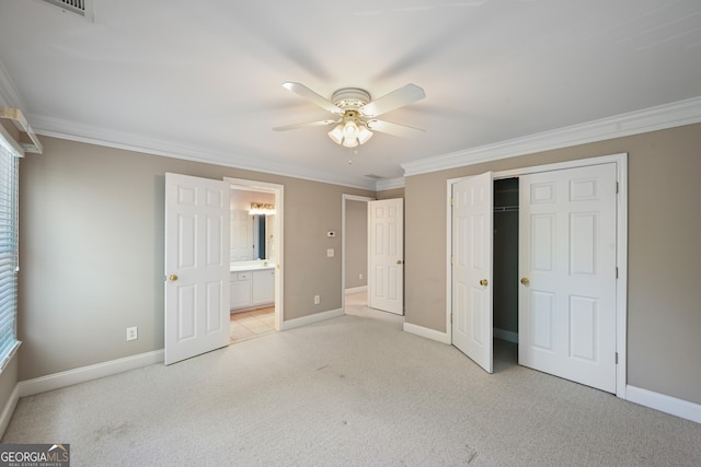 unfurnished bedroom with light colored carpet, ornamental molding, ceiling fan, and a closet