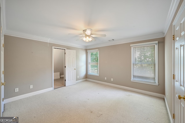 unfurnished bedroom featuring carpet, ceiling fan, and crown molding