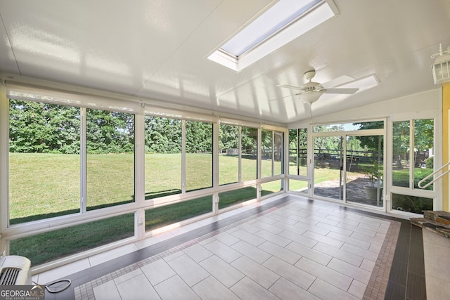 unfurnished sunroom featuring a wealth of natural light, ceiling fan, and lofted ceiling with skylight