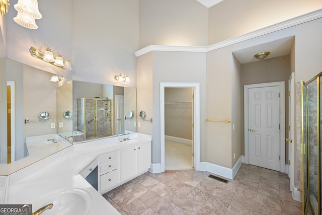 bathroom with a towering ceiling, tile flooring, large vanity, and dual sinks