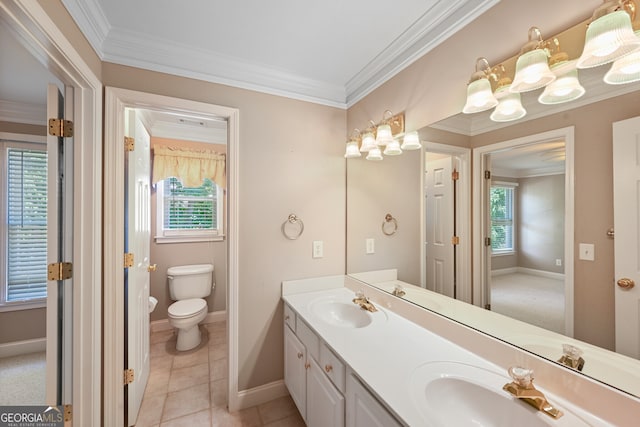 bathroom with crown molding, double sink, tile floors, vanity with extensive cabinet space, and toilet