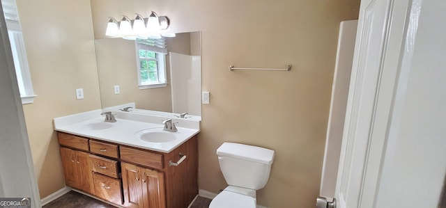 bathroom featuring toilet and vanity