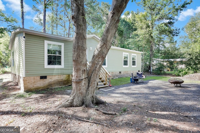 back of property featuring an outdoor fire pit