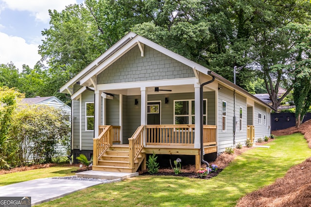 bungalow with a front yard and ceiling fan