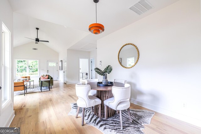 kitchen featuring white cabinets, light wood-type flooring, and pendant lighting