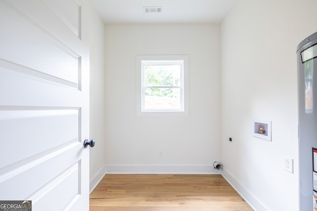 clothes washing area featuring hardwood / wood-style flooring, hookup for an electric dryer, and washer hookup