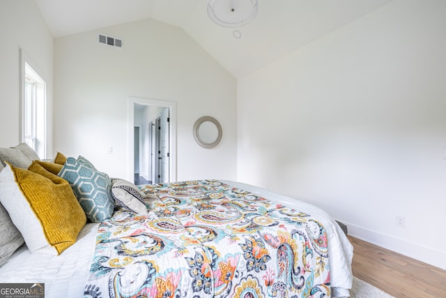 bedroom featuring lofted ceiling and wood-type flooring