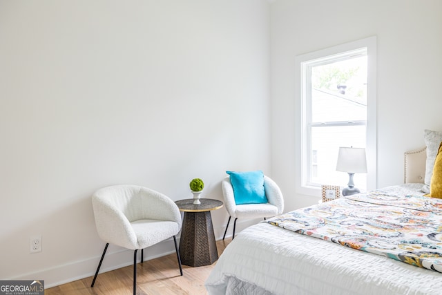 bedroom featuring multiple windows and light hardwood / wood-style floors