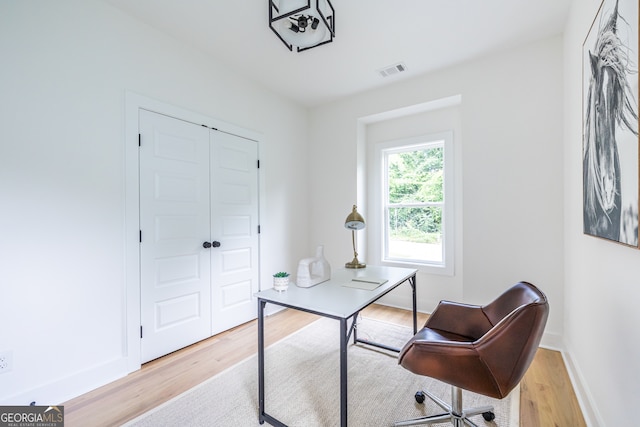 office with light hardwood / wood-style floors