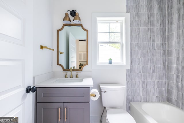 full bathroom featuring vanity, toilet, and tiled shower / bath combo