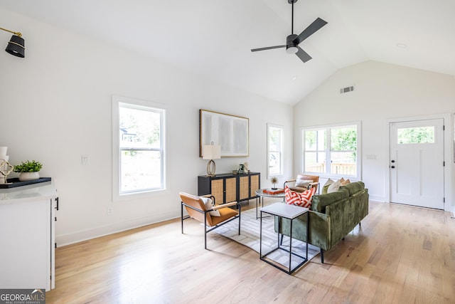 living room with high vaulted ceiling, light wood-type flooring, and ceiling fan