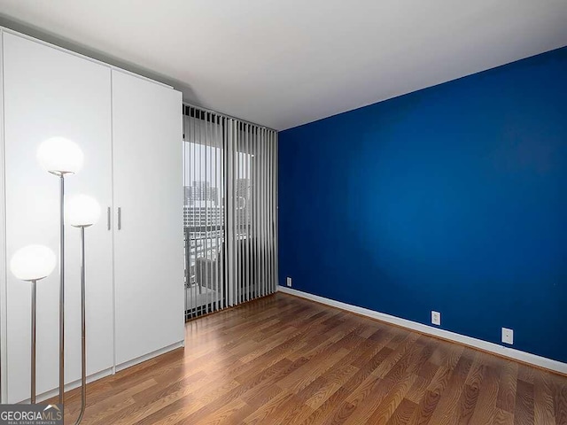 empty room with wood-type flooring