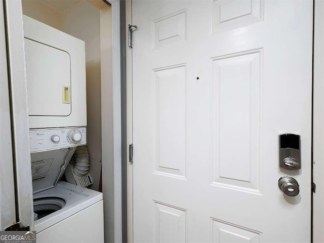 washroom featuring stacked washer / drying machine