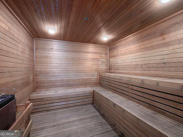 view of sauna featuring wood walls, hardwood / wood-style flooring, and wooden ceiling