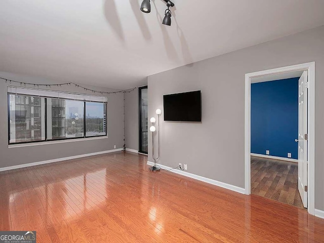 unfurnished living room featuring hardwood / wood-style flooring