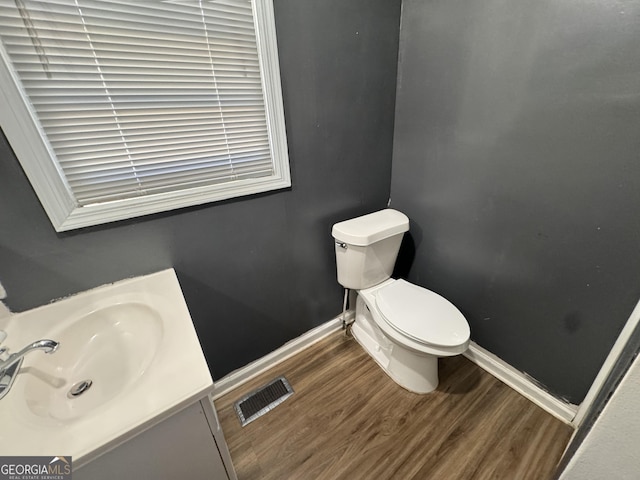 bathroom featuring vanity, hardwood / wood-style floors, and toilet